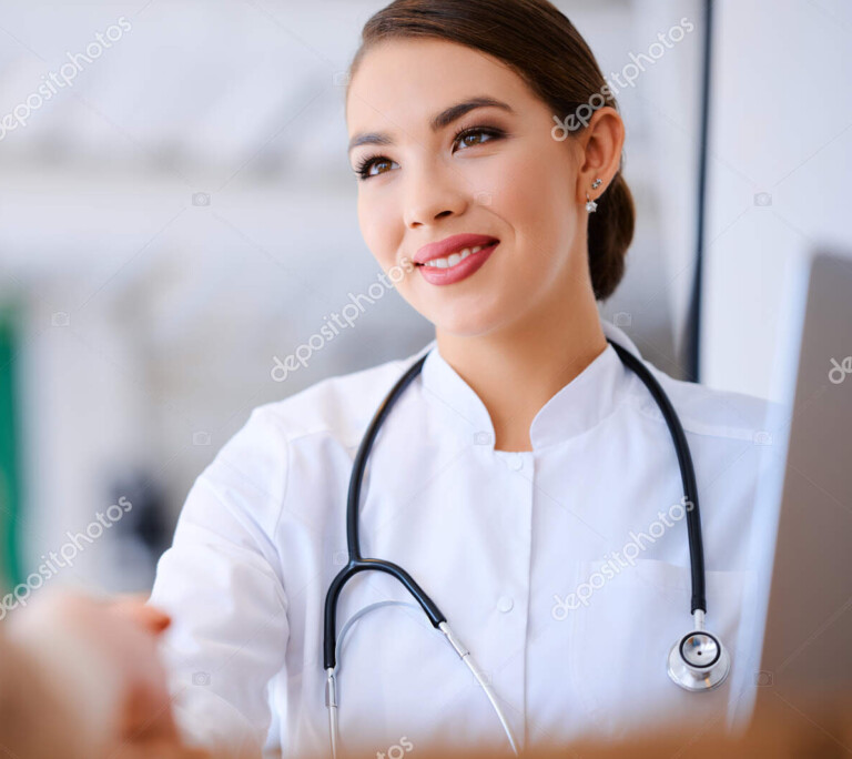 female doctor shaking hands with the patient in the office