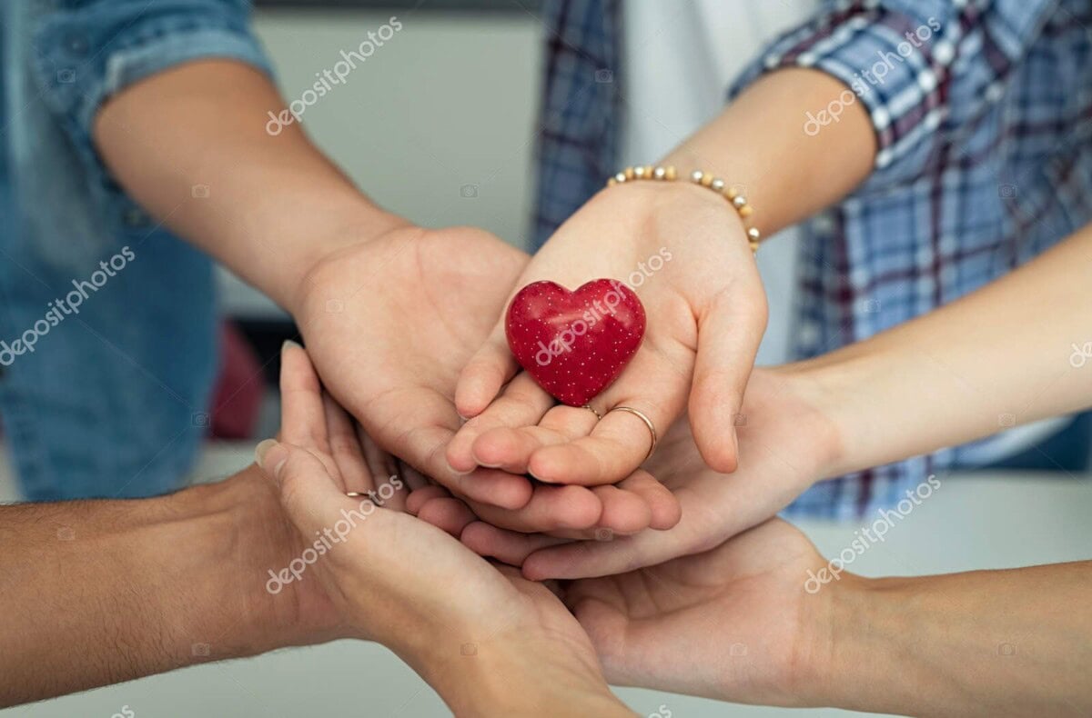 young friends holding heart stone