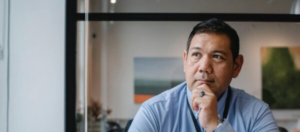 man thinking while using laptop