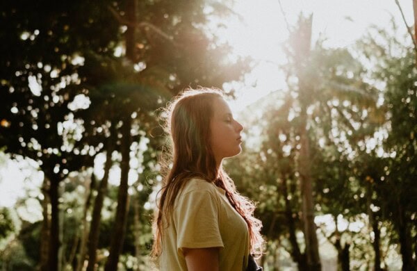 woman standing eyes closed