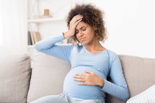 woman pregnant with headache