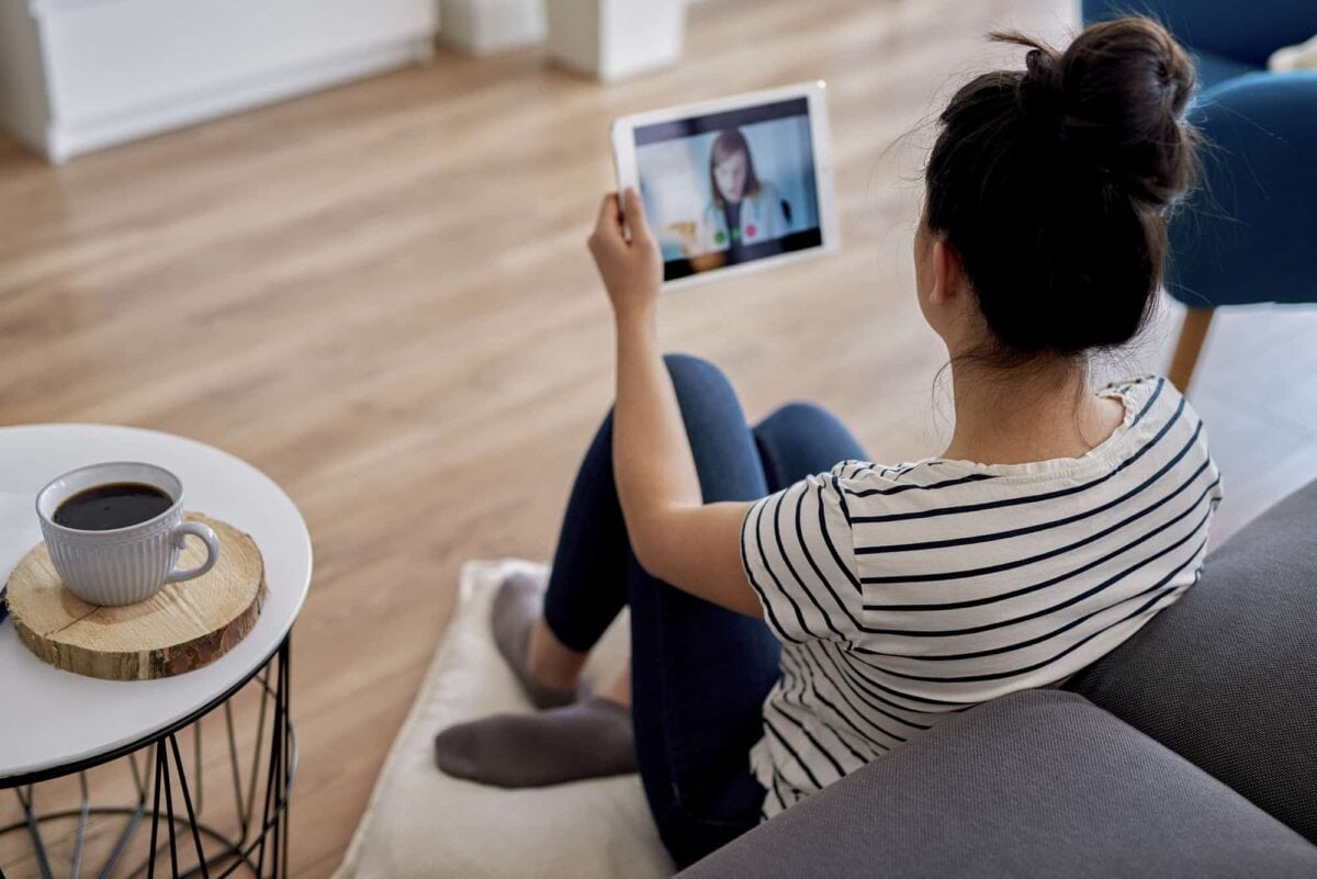 woman using tablet sitting