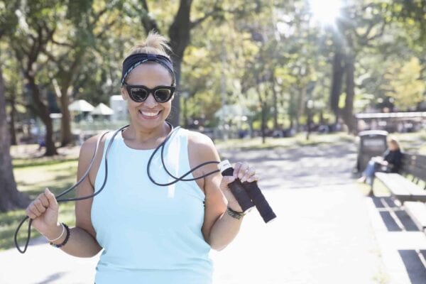 woman smiling while holding a rope