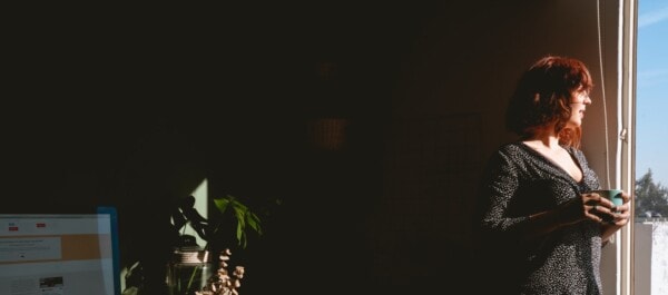 woman looking from the window