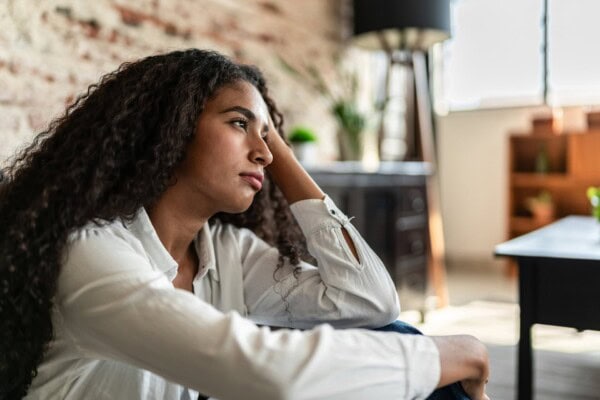 worried young woman contemplating at home
