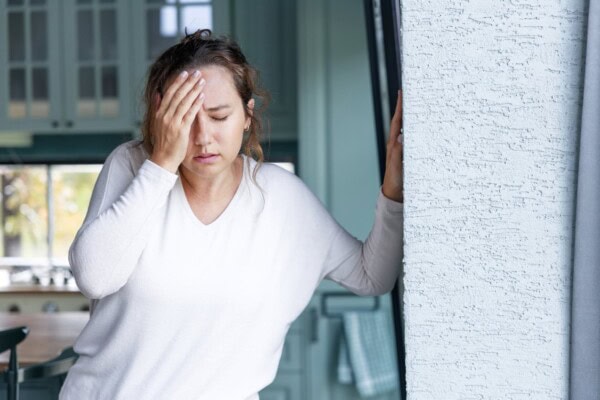 young woman suffering from vertigo or dizziness problem of brain or inner ear